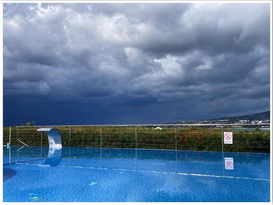 Paphos in winter rain storm over pool